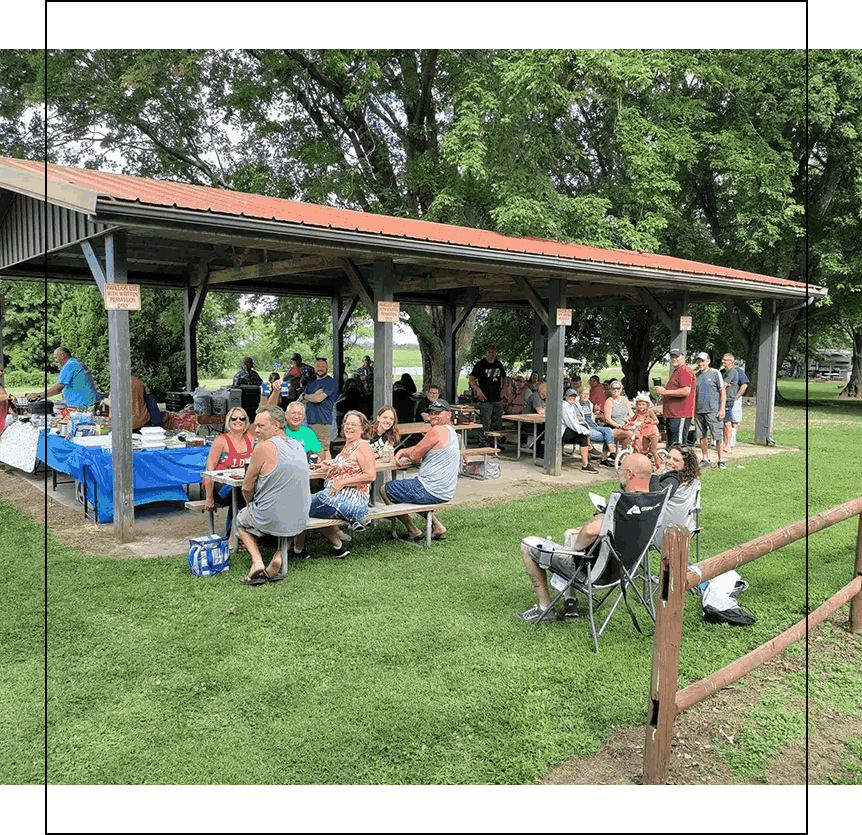 A group of people sitting at the picnic pavilion at Gotta Getaway RV Park